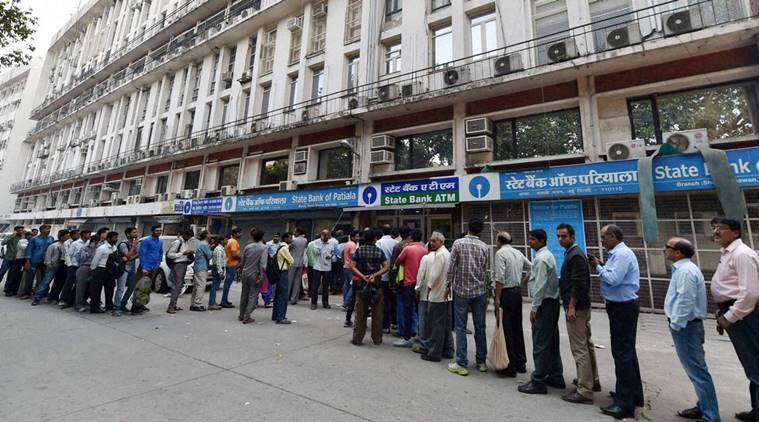 New Delhi: People queue up at out side of banks ATM to get money in New Delhi on Sunday. PTI photo by Vijay Verma(PTI11_13_2016_000071A)