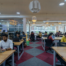 Professionals working in a modern coworking space near Silk Board with open desks, meeting rooms, and collaborative startup environment